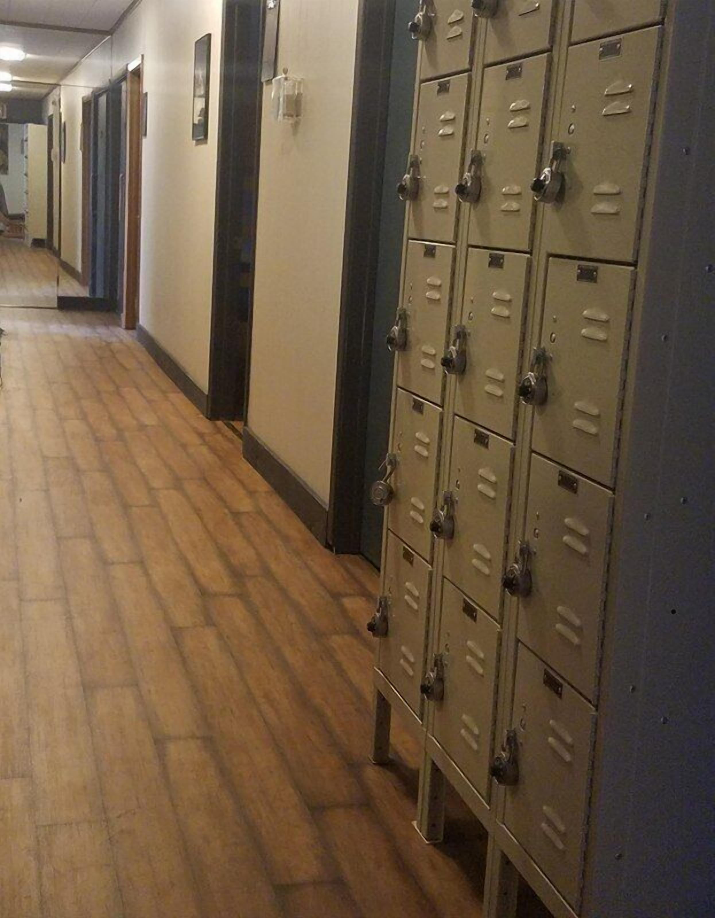 A hallway with lockers and doors.