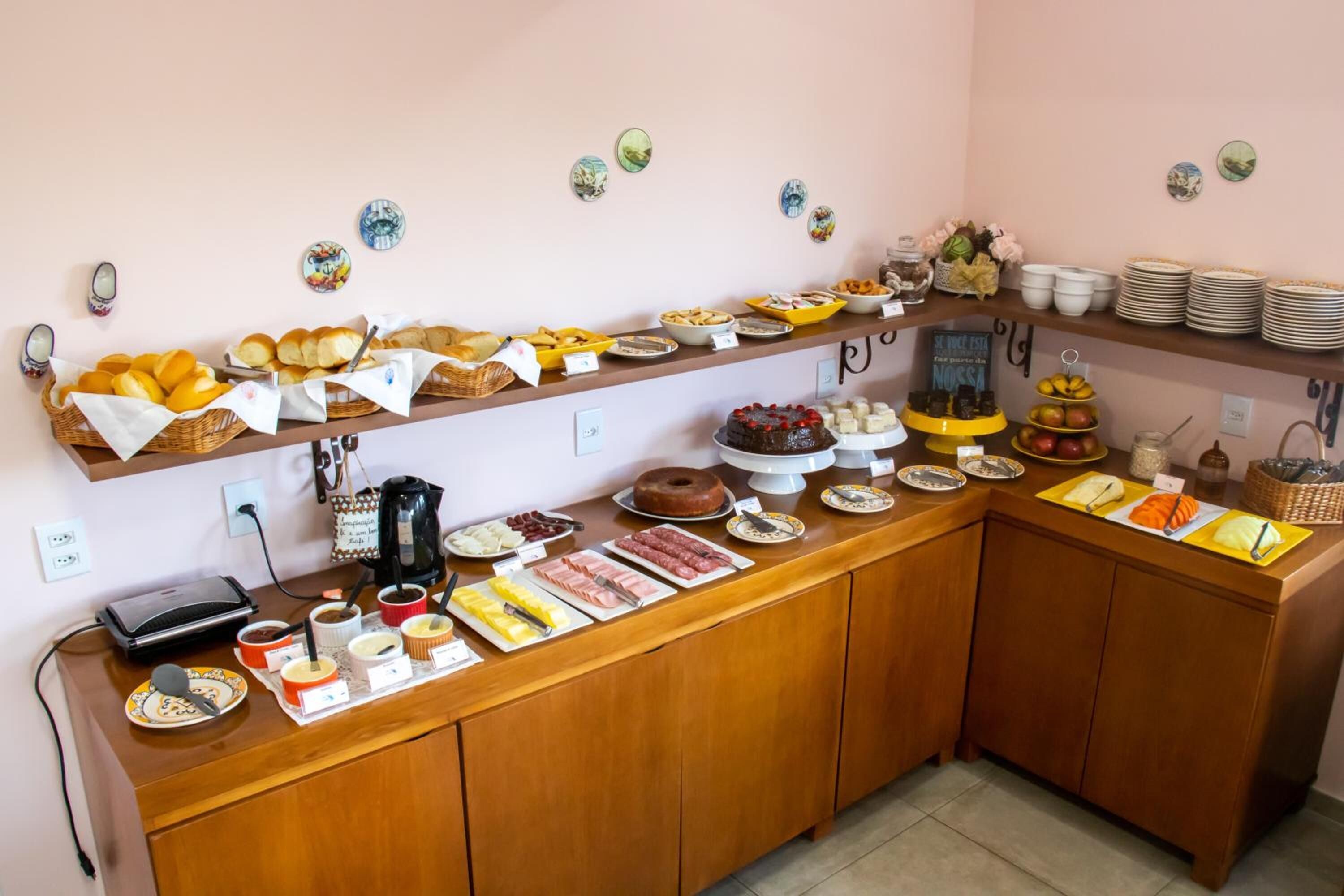 A buffet setup with various food items and a coffee station.