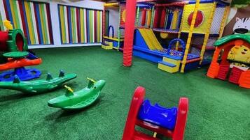 Kids can play and climb in this fun play area with a slide, climbing net, and playhouse.