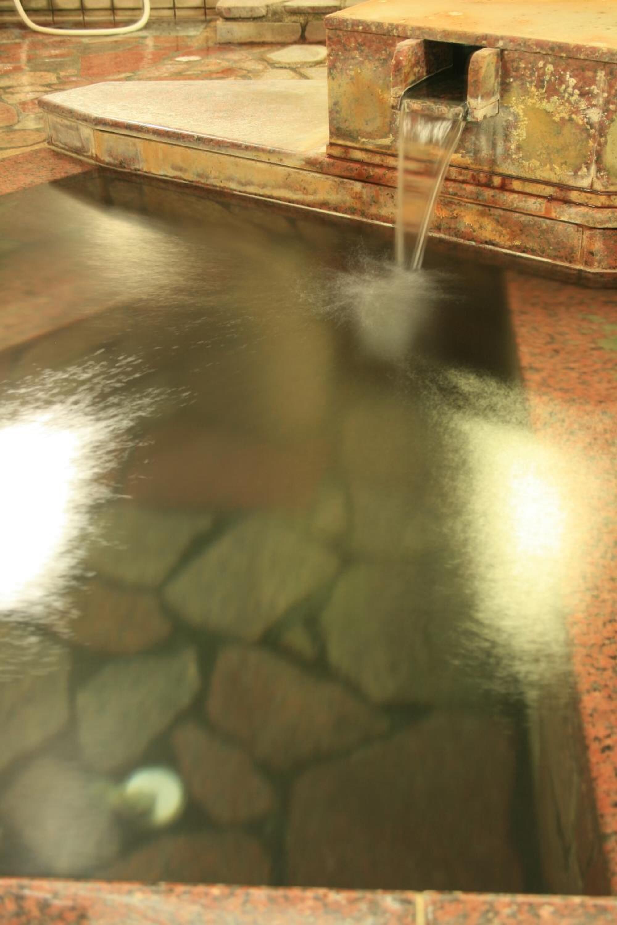 A stone-lined pool with a water feature.
