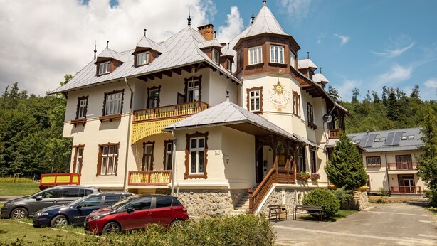 Ein großes, mehrgeschossiges Gebäude im traditionellen Baustil, mit einem markanten Turm und mehreren Balkonen.