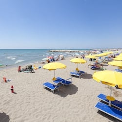 Playa privada, arena blanca, sillas reclinables de playa, sombrillas