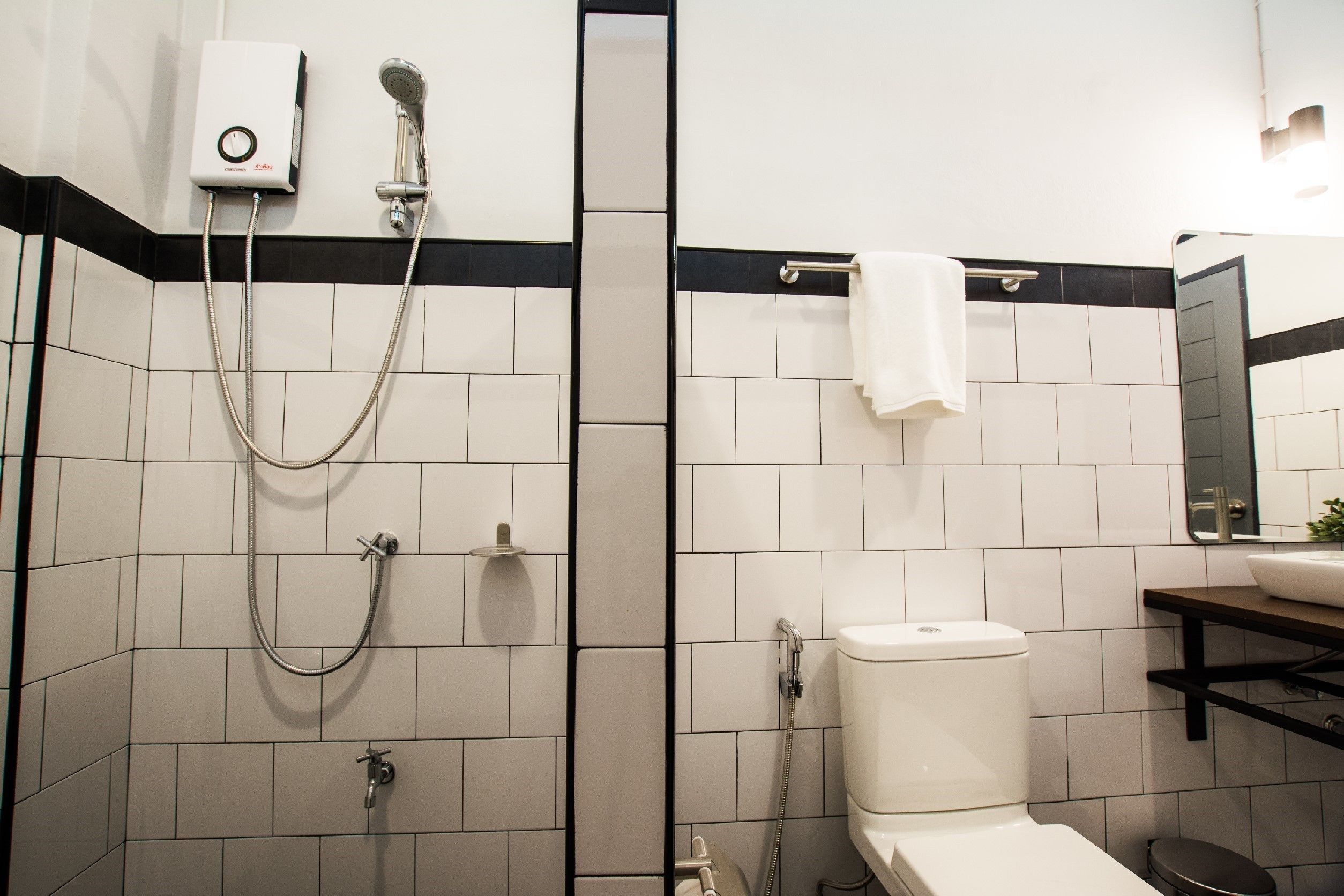 A modern bathroom with a shower, toilet, and sink.