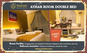 A double bed in a room with a luggage rack, AC, multiple TV channels, telephone, hot & cool water, and a key card. The bathroom amenities include shampoo & conditioner, a dental kit, and a towel. - Hazotel Semarang (Semarang)