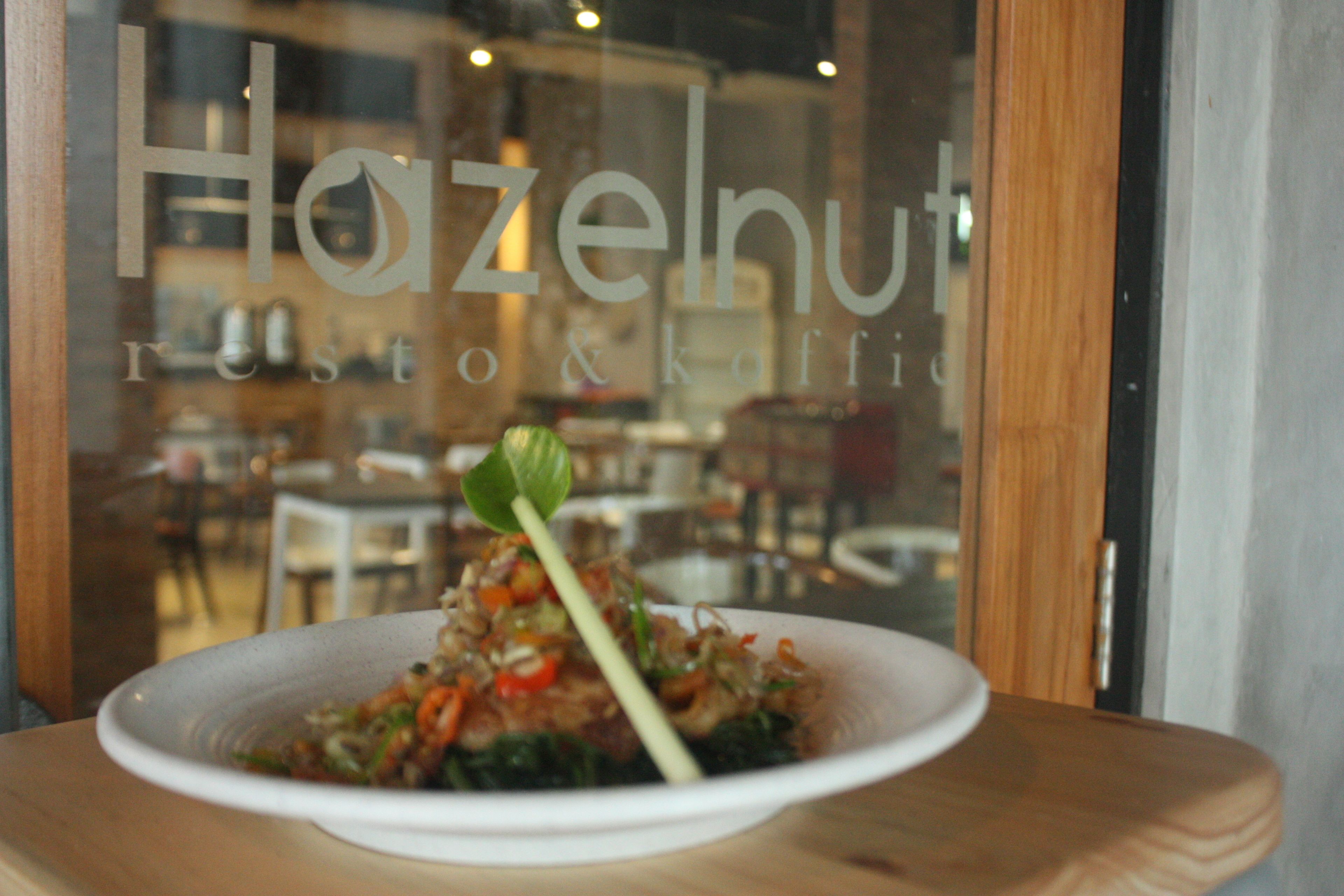 A restaurant window with a plate of food on a table.