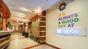 A hotel reception area with a sign saying "It's always a good day at Treebo." - Treebo Sam Residency (Coimbatore)