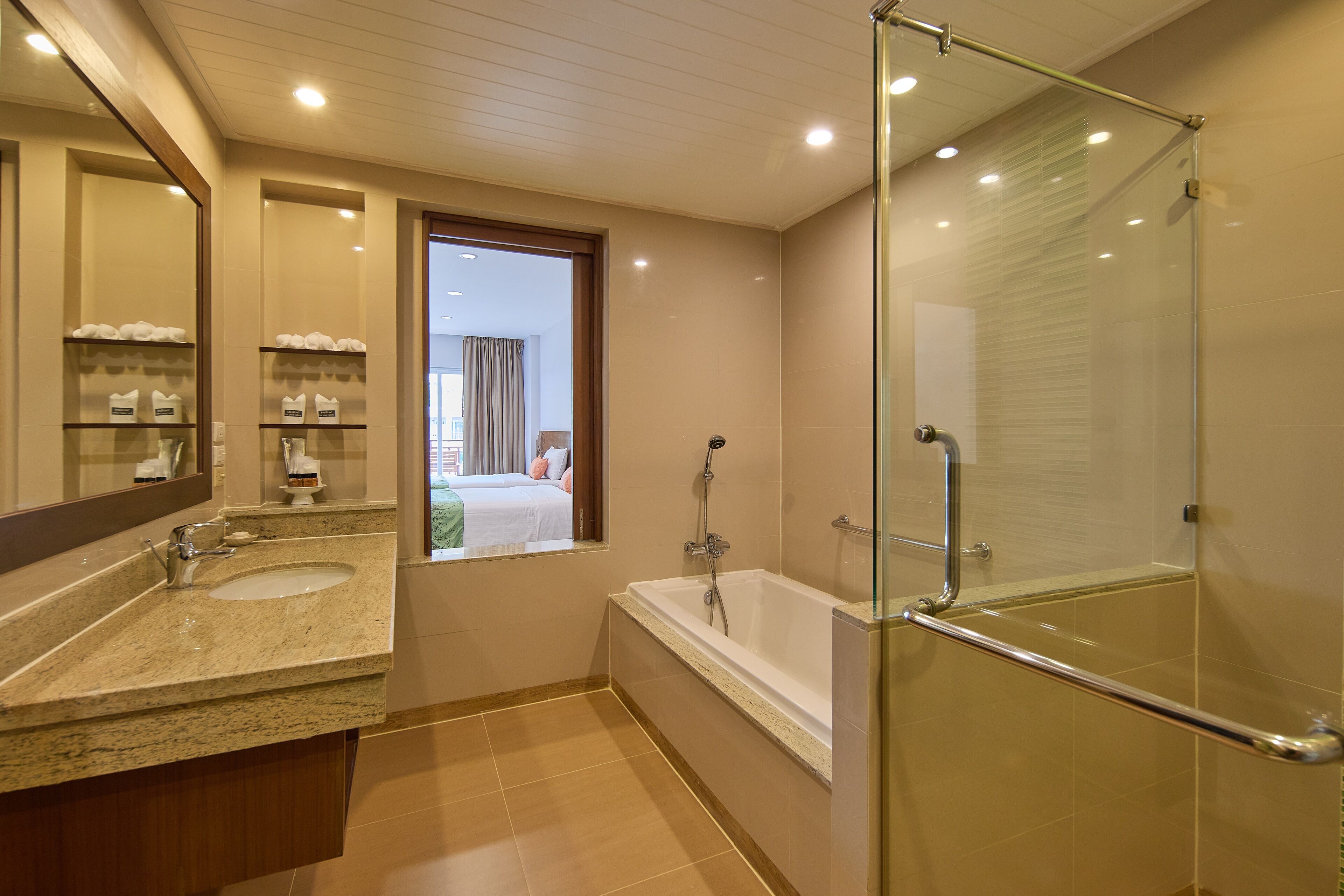 A modern bathroom with a double sink, a bathtub, and a glass-enclosed shower.