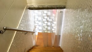 A staircase with a metal handrail and a tiled wall. - Hotel BKC Palace (Mumbai)