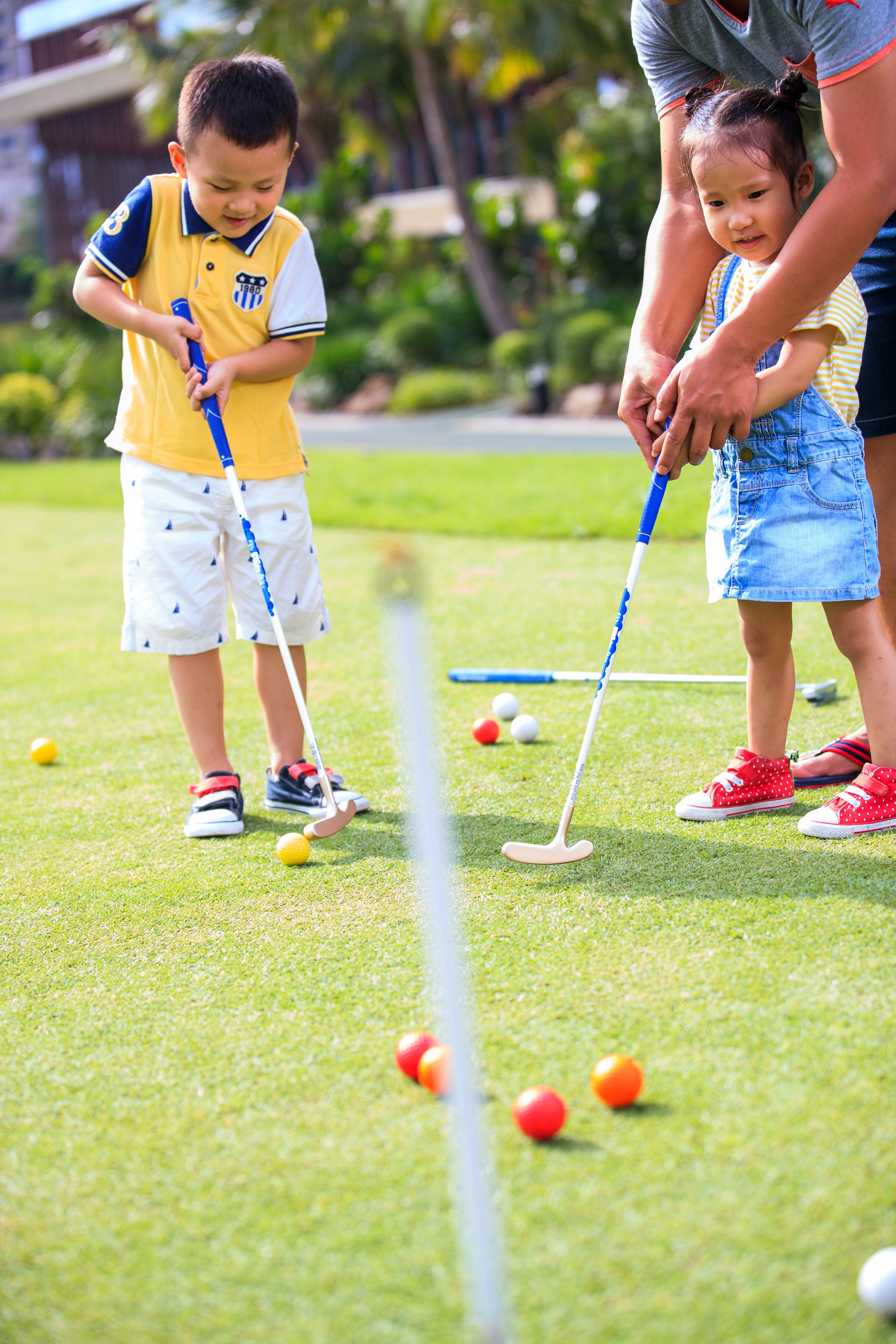 A golf course with players and a golf club.