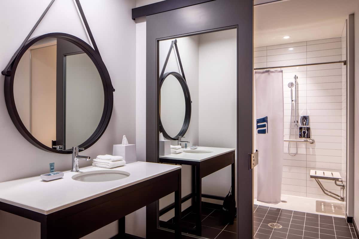 Shower, designer toiletries, hair dryer, towels