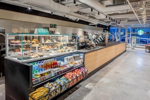 A bakery display with pastries and a refrigerated section with beverages and snacks.