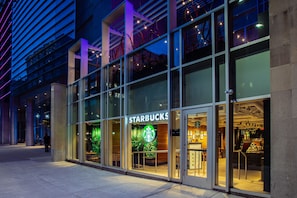 A Starbucks store with large glass windows and a modern architectural design.