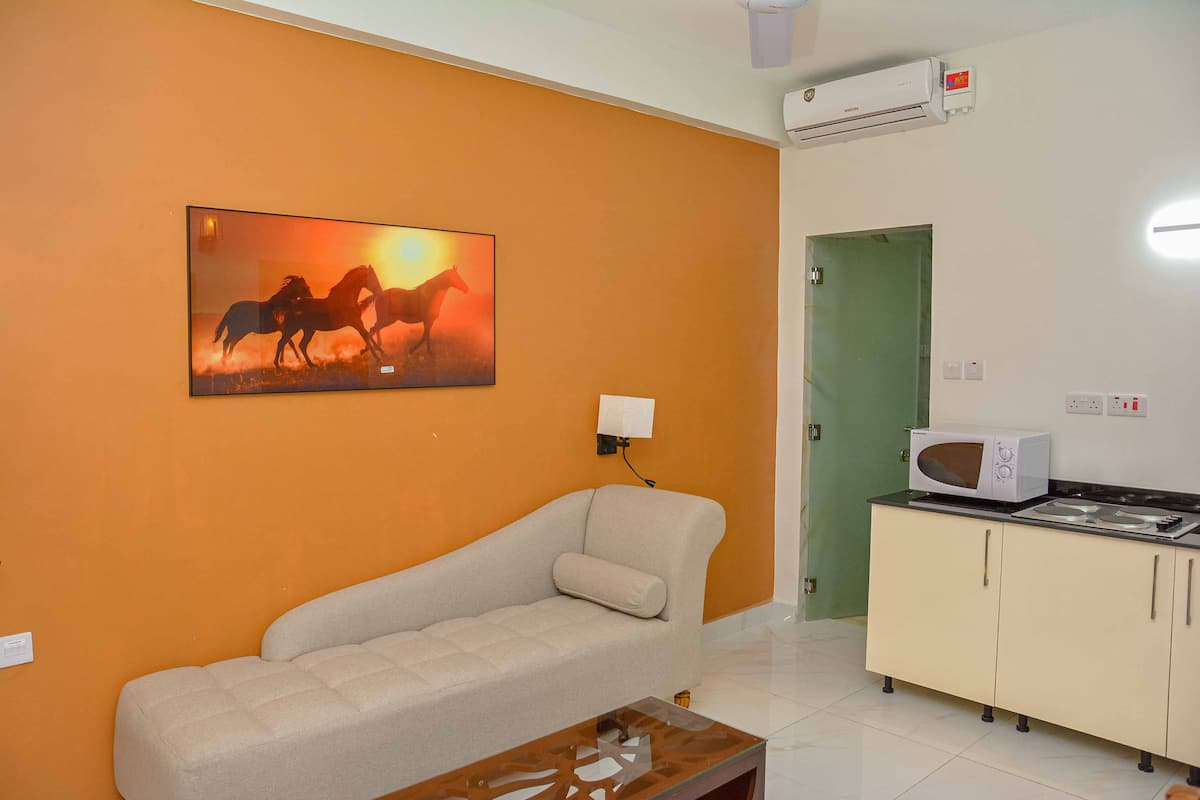 suite room with living room including kitchen, jacuzzi in the room | living area | 53-inch smart tv with digital channels, tv, netflix