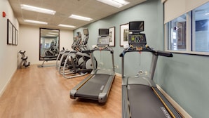 A gym with treadmills, stationary bikes, and a weight machine. - Drury Plaza Hotel St. Louis St. Charles (St. Charles)