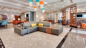 A spacious lobby with a large sectional sofa, a reception desk, and a bar area. - Drury Plaza Hotel St. Louis St. Charles (St. Charles)