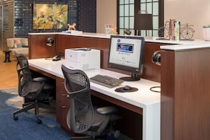 A modern office cubicle with a desktop computer, printer, and two office chairs. - Hampton Inn & Suites Portland-Pearl District (Portland)