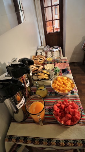 Enjoy a delicious breakfast spread with a variety of bread, pastries, fresh fruits, and hot beverages.