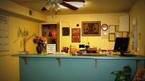 A reception desk with a sign indicating pets are allowed with permission only.