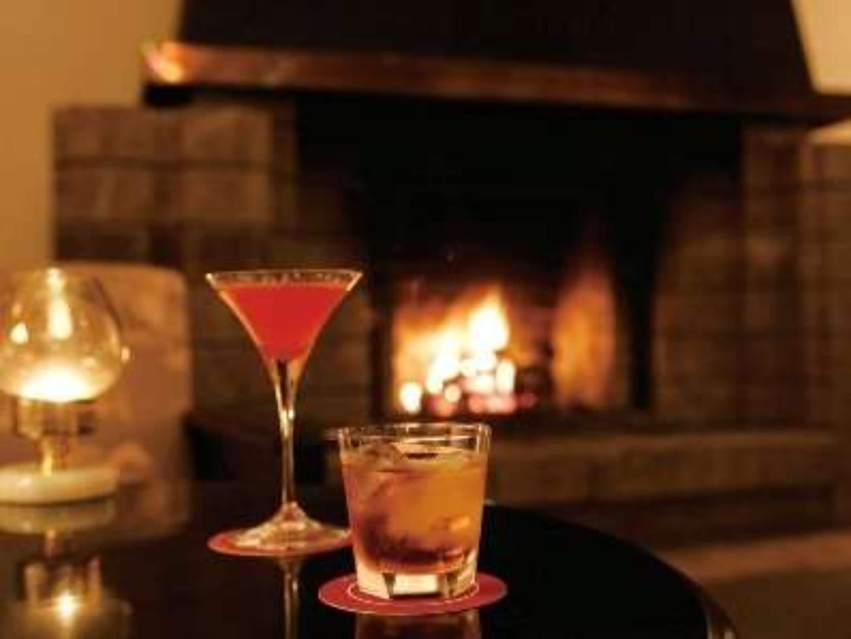 A bar area with a fireplace in the background.