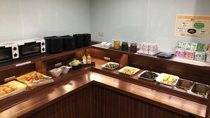A buffet setup with various food items and condiments. - Business Hotel Fiz Nagoya Airport (Toyoyama)