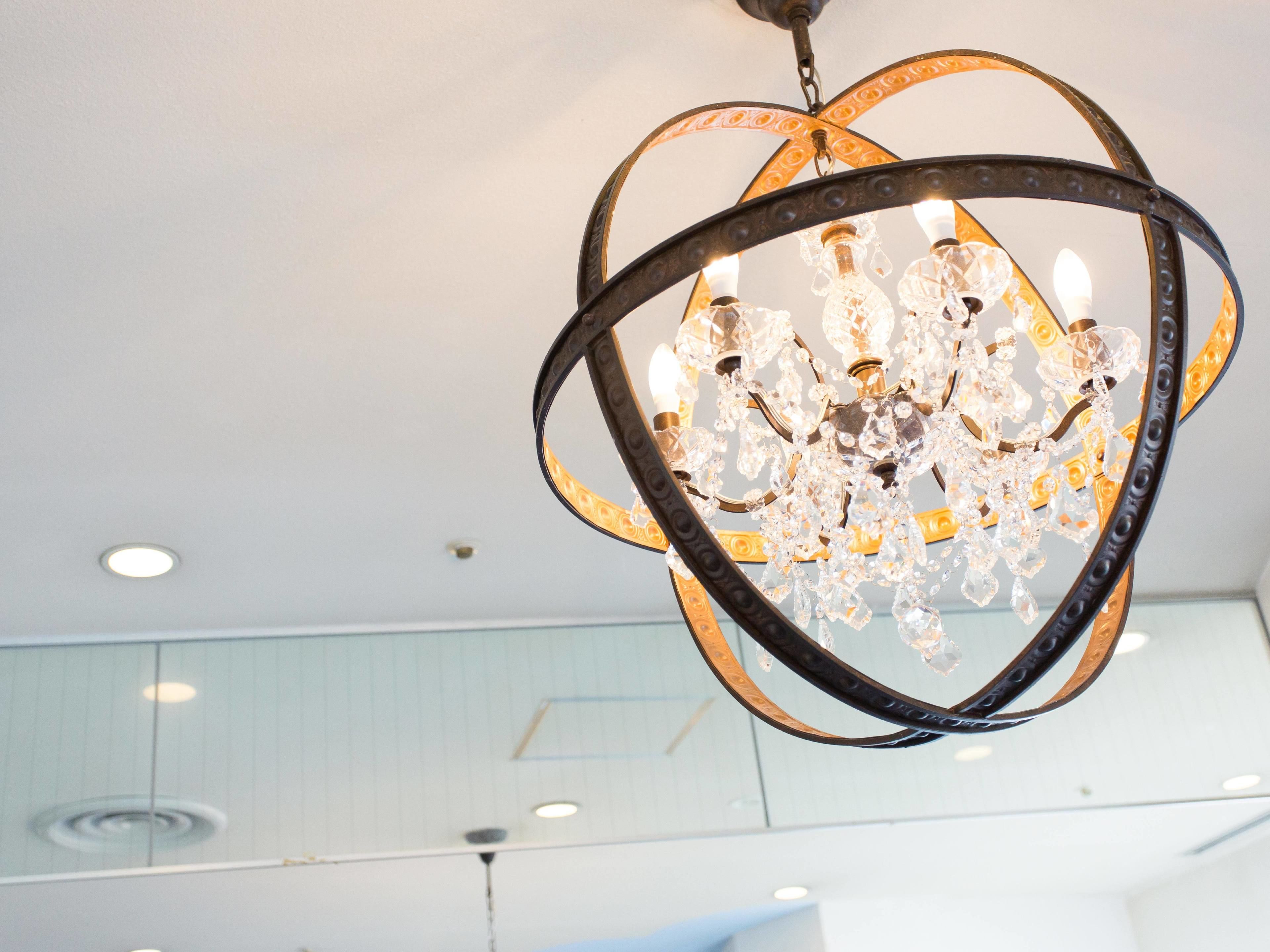 A chandelier with multiple crystal bulbs hanging from a metal frame.