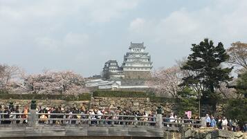A traditional Japanese castle with a stone bridge in the foreground.
