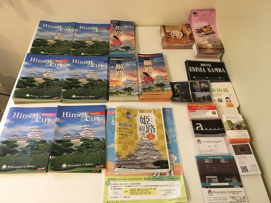 A collection of travel guides and promotional materials for Himeji City, including various book covers and brochures.