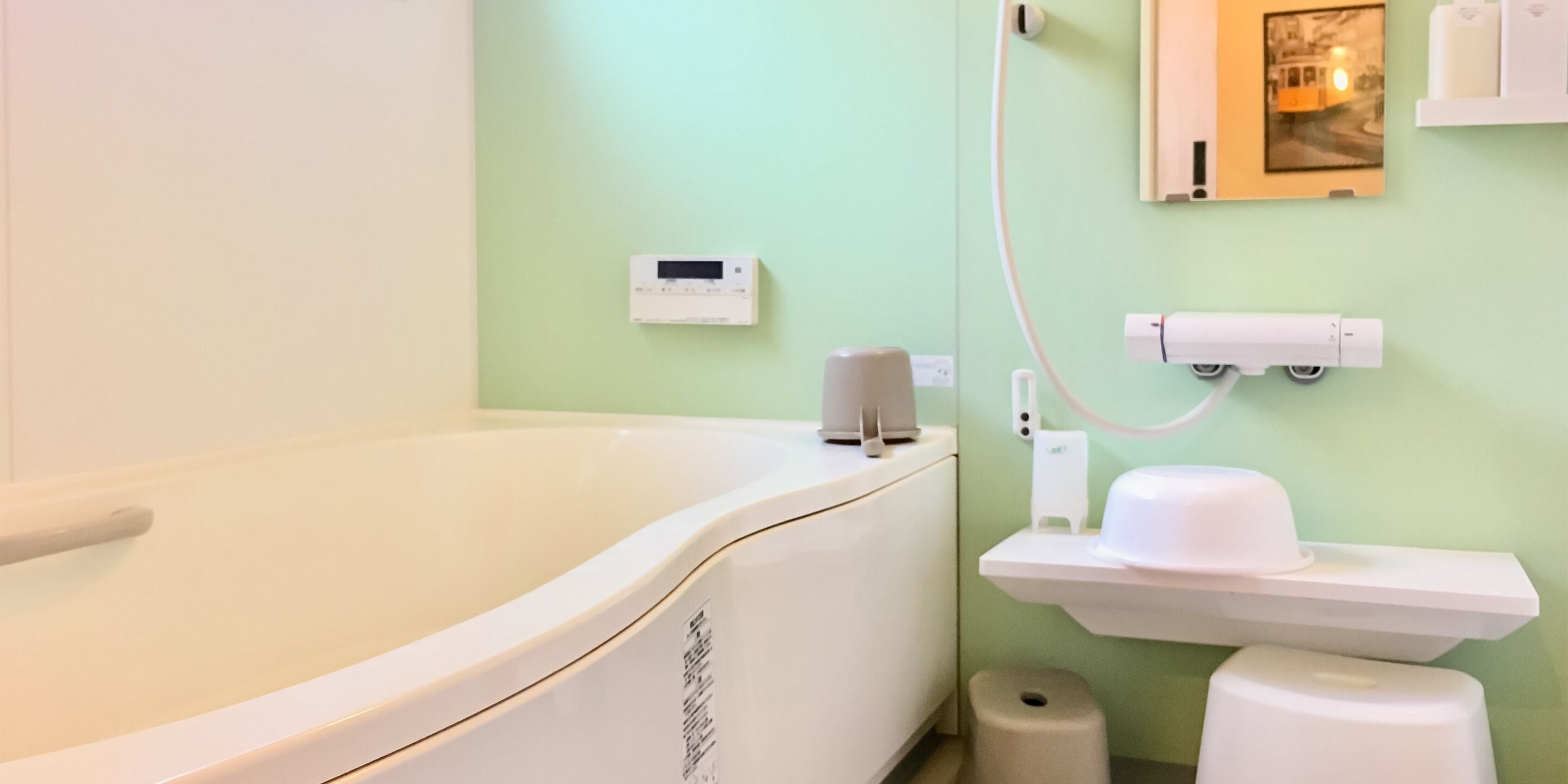 A bathroom with a bathtub, a toilet, a sink, and a wall-mounted heater.
