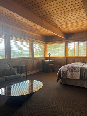 A room with a bed, a round table, and a bench. - Private Chef included for Breakfast and Dinners.  Meeting room, ultimate privacy (Breckenridge)
