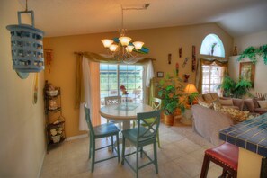 Enjoy meals in this inviting dining area with a round table and comfortable seating for four.