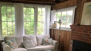 Ein gemütliches Wohnzimmer mit Sofa, Couchtisch und Kamin.