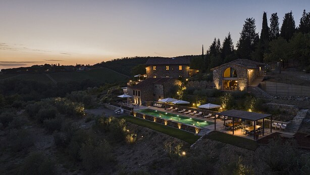 A large stone house with a swimming pool and outdoor seating area, surrounded by hills and trees. - ISOLA SERENA Newly Expanded Private Luxury Villa, Tuscany, Infinity Pool & Views (Castellina in Chianti)