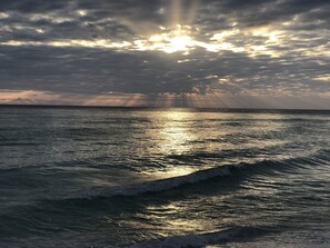 A sunset over the ocean with waves.