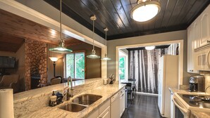 A kitchen with granite countertops, stainless steel appliances, and pendant lighting. - Lake Front, PETS, Theater, Dock, Swim-Fish-Boat,  Fire Pit, NEW BOAT, Pickleball (Waleska)