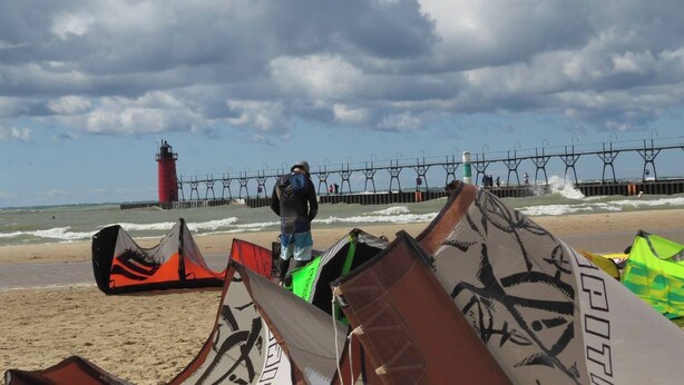 A beach with windsurfing equipment and a lighthouse in the background. - Downtown South Haven, close to everything,  family friendly, very clean (South Haven)