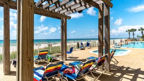 A wooden pergola with beach chairs and a pool area. - 4th Newest Beachfront Condo! 100% No Smoking (Panama City Beach)