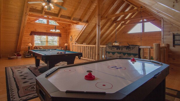 A wooden interior with a pool table and shuffleboard table. - New Arcade 2-Pools 1 Pool YR RD ,Hot Tub,Mini Golf,FREE WIFI,Game Room (Pigeon Forge)