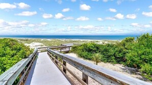A wooden boardwalk leading to a beach with a clear view of the ocean and a sandy landscape. - Spectacular Ocean Front Amelia Island Plantation, Breathtaking Ocean View  (Fernandina Beach)