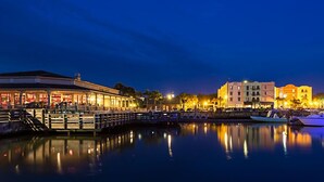 A waterfront hotel with a dock, reflecting buildings, and boats. - Spectacular Ocean Front Amelia Island Plantation, Breathtaking Ocean View  (Fernandina Beach)