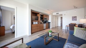 A modern apartment with a living room, a kitchen, and a dining area.
