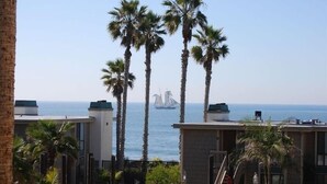 A coastal hotel with palm trees and a view of the sea. - OCEANFRONT White Water Views Unit E-100  SEASONAL RATES AVAILABLE PLEASE INQUIRE (Oceanside)