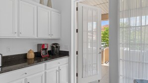 A kitchen with white cabinets, a coffee maker, and a jar on the counter. - 20 yrds to water! BBQ, Scalloping And Manatee Watching, Families welcome!  (Homosassa)
