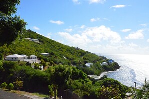 A coastal area with houses on a hillside, overlooking the sea.