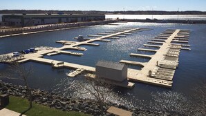 An aerial view of a marina with multiple docks and a small building.
