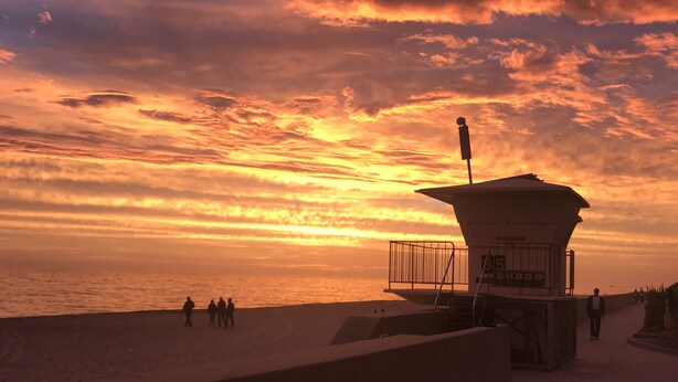 A lifeguard tower at a beach during sunset with a clear sky and calm sea. - Enjoyable and Luxurious Carlsbad Village Beach House 1/2 Block to Beach (Carlsbad)