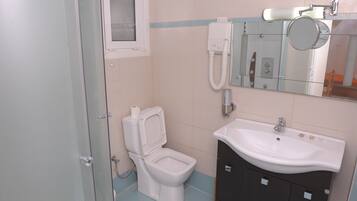 Shower, hair dryer, towels, toilet paper