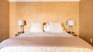 A neatly made bed with white linens and a beige throw blanket, flanked by two bedside lamps on matching nightstands. - BEST LOCATION: Historic Shepherdstown Getaway (Shepherdstown)