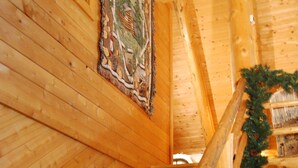 A wooden staircase with a handrail, wooden walls, and a framed picture on the wall. - Private log cabin with hot tub and mountain views on 14 acres, pet friendly! (N.Ferrisburgh)