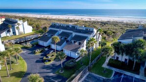 A beachfront hotel with multiple buildings, a parking area, and a view of the ocean. - Ocean View Beachfront Getaway Directly on St. Augustine Beach.  (St. Augustine Beach)