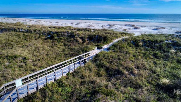 A wooden boardwalk leading to a beach with a clear view of the ocean. - Ocean View Beachfront Getaway Directly on St. Augustine Beach. (St. Augustine Beach)